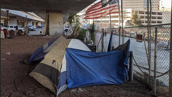 Homeless_tents_and_flag_under_CA-87_in_San_Jose.jpg