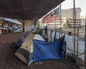 Homeless_tents_and_flag_under_CA-87_in_San_Jose.jpg